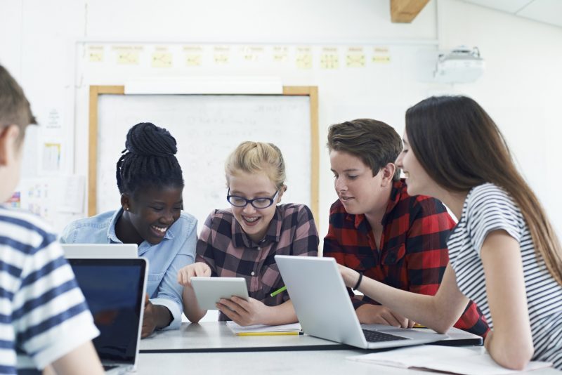 Digital future group of teenagers on laptops