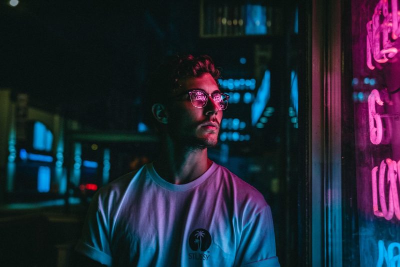 Young person looking at shop lights Young person looking at shop lights